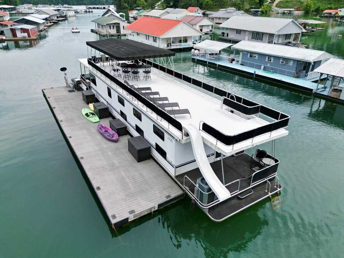 a large ship in the water aboard 2012 MAJESTIC 16 X 75WB HOUSEBOAT NLSD Yacht for Sale