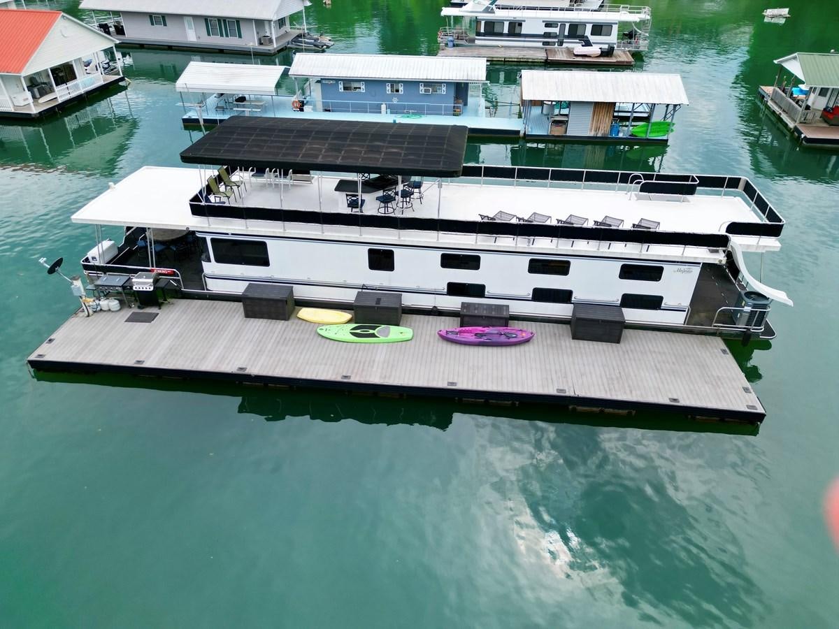 a boat on the water aboard 2012 MAJESTIC 16 X 75WB HOUSEBOAT NLSD Yacht for Sale