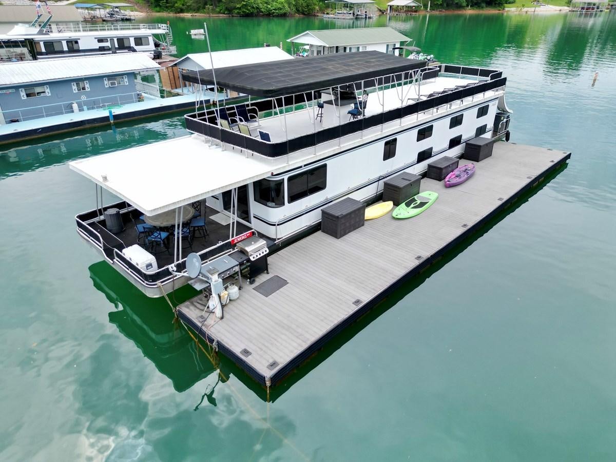 a boat on the water aboard 2012 MAJESTIC 16 X 75WB HOUSEBOAT NLSD Yacht for Sale