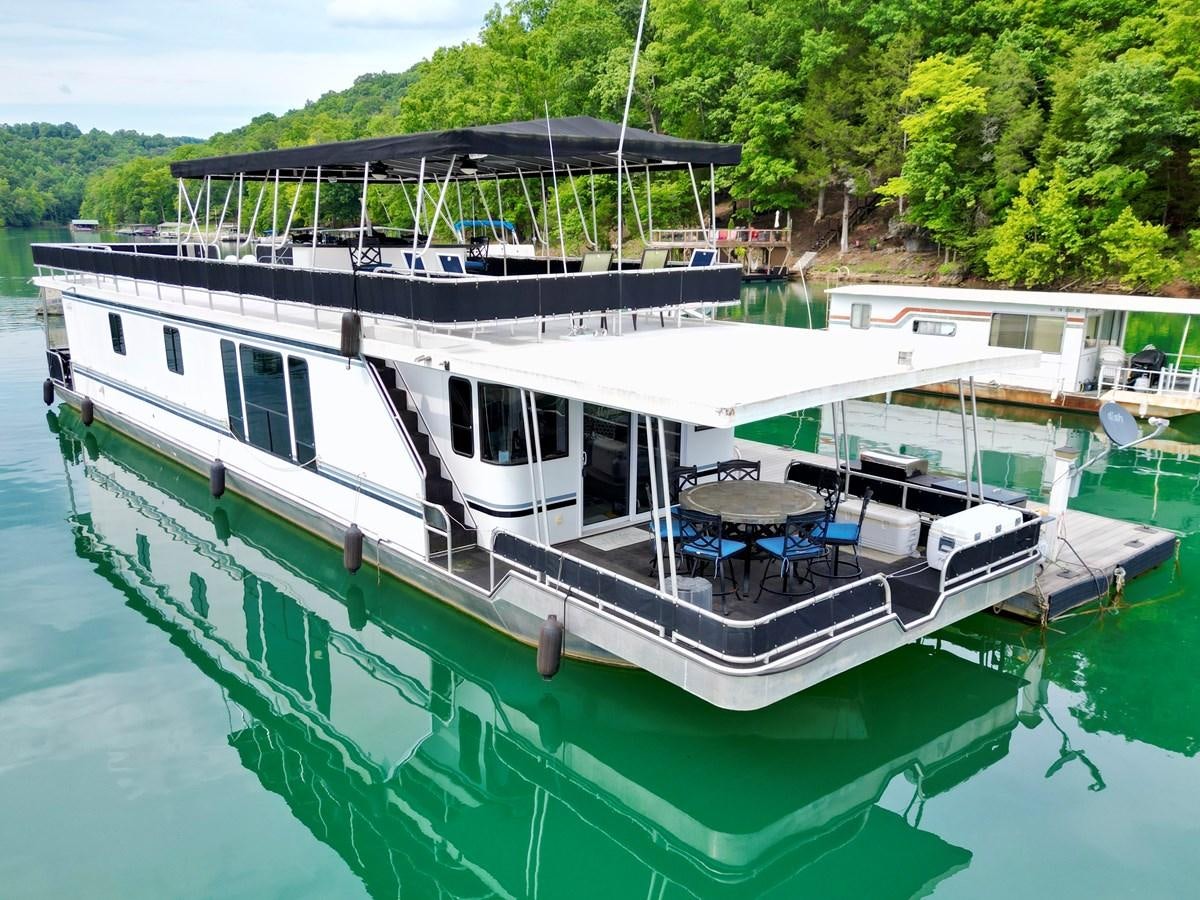 a boat docked at a pier aboard 2012 MAJESTIC 16 X 75WB HOUSEBOAT NLSD Yacht for Sale