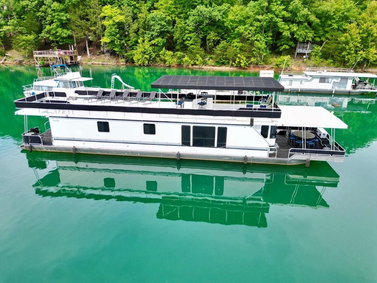 a boat docked at a pier aboard 2012 MAJESTIC 16 X 75WB HOUSEBOAT NLSD Yacht for Sale