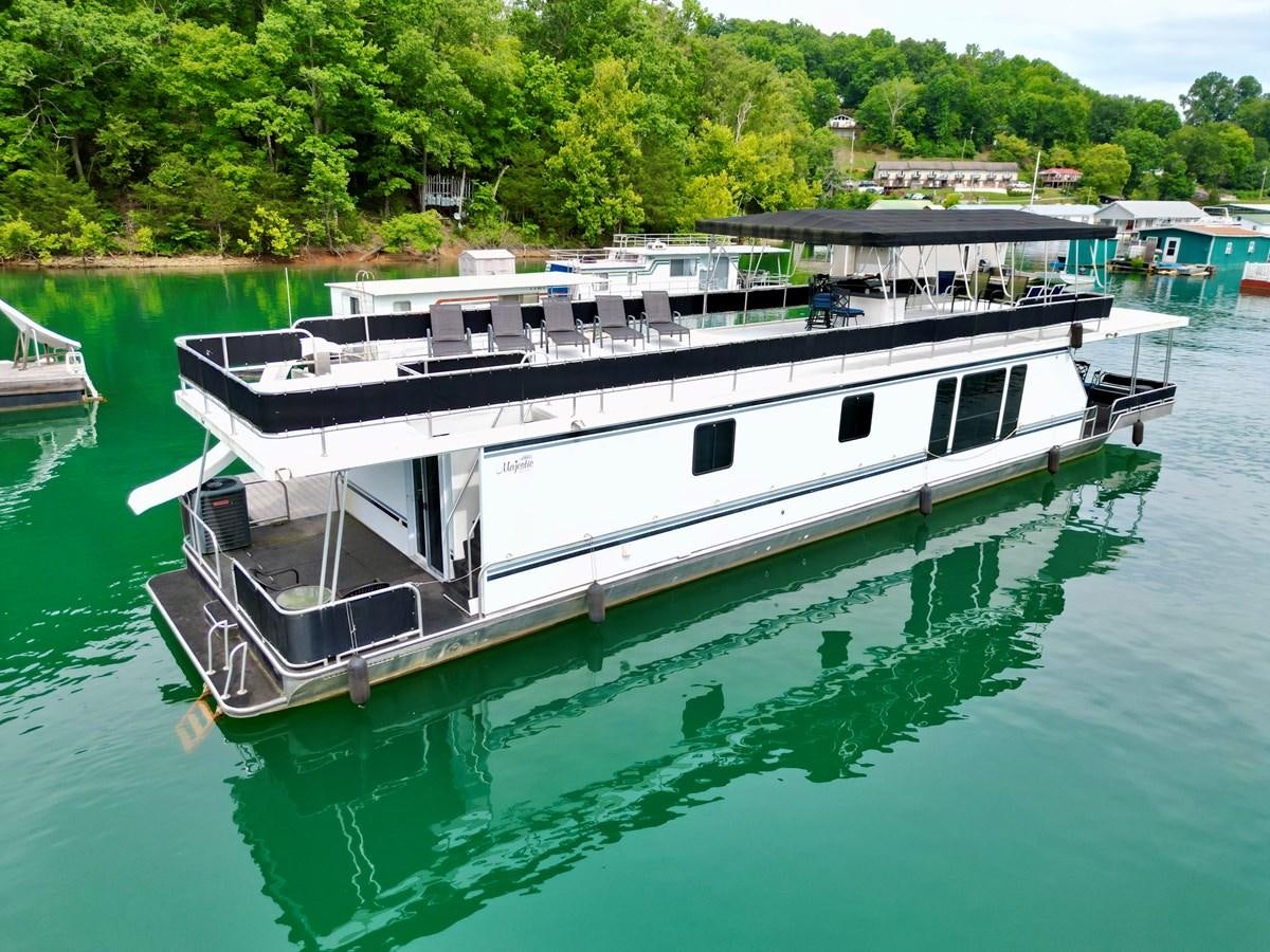 a boat on the water aboard 2012 MAJESTIC 16 X 75WB HOUSEBOAT NLSD Yacht for Sale