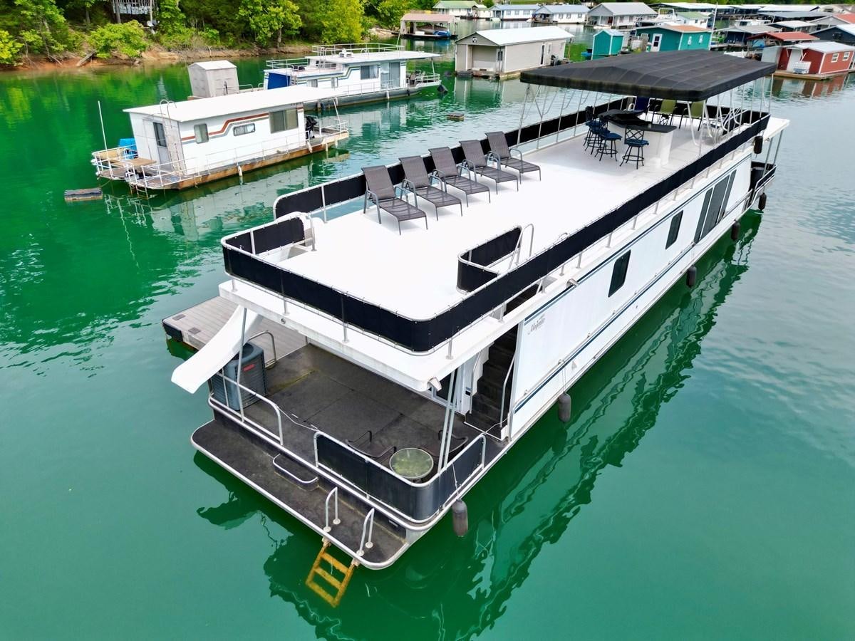 a boat on the water aboard 2012 MAJESTIC 16 X 75WB HOUSEBOAT NLSD Yacht for Sale