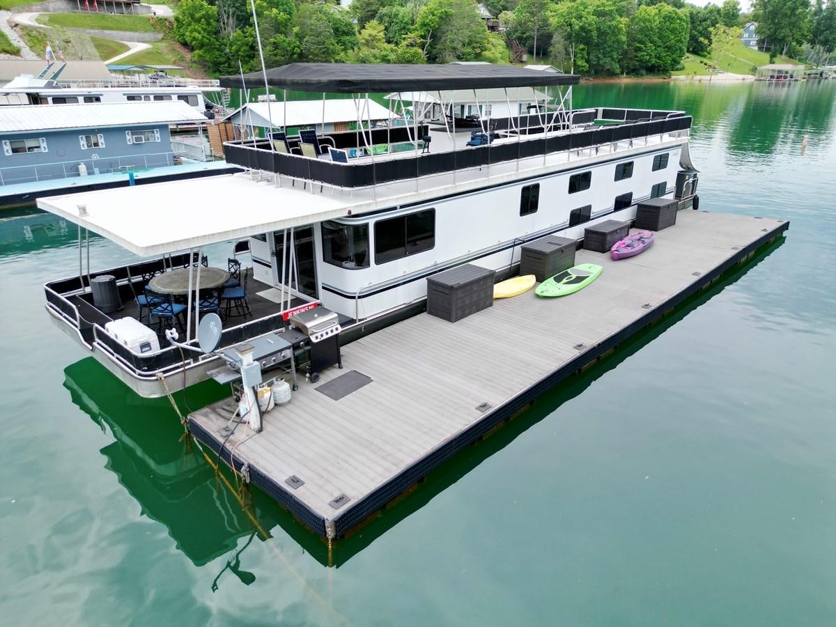 a boat docked at a pier aboard 2012 MAJESTIC 16 X 75WB HOUSEBOAT NLSD Yacht for Sale
