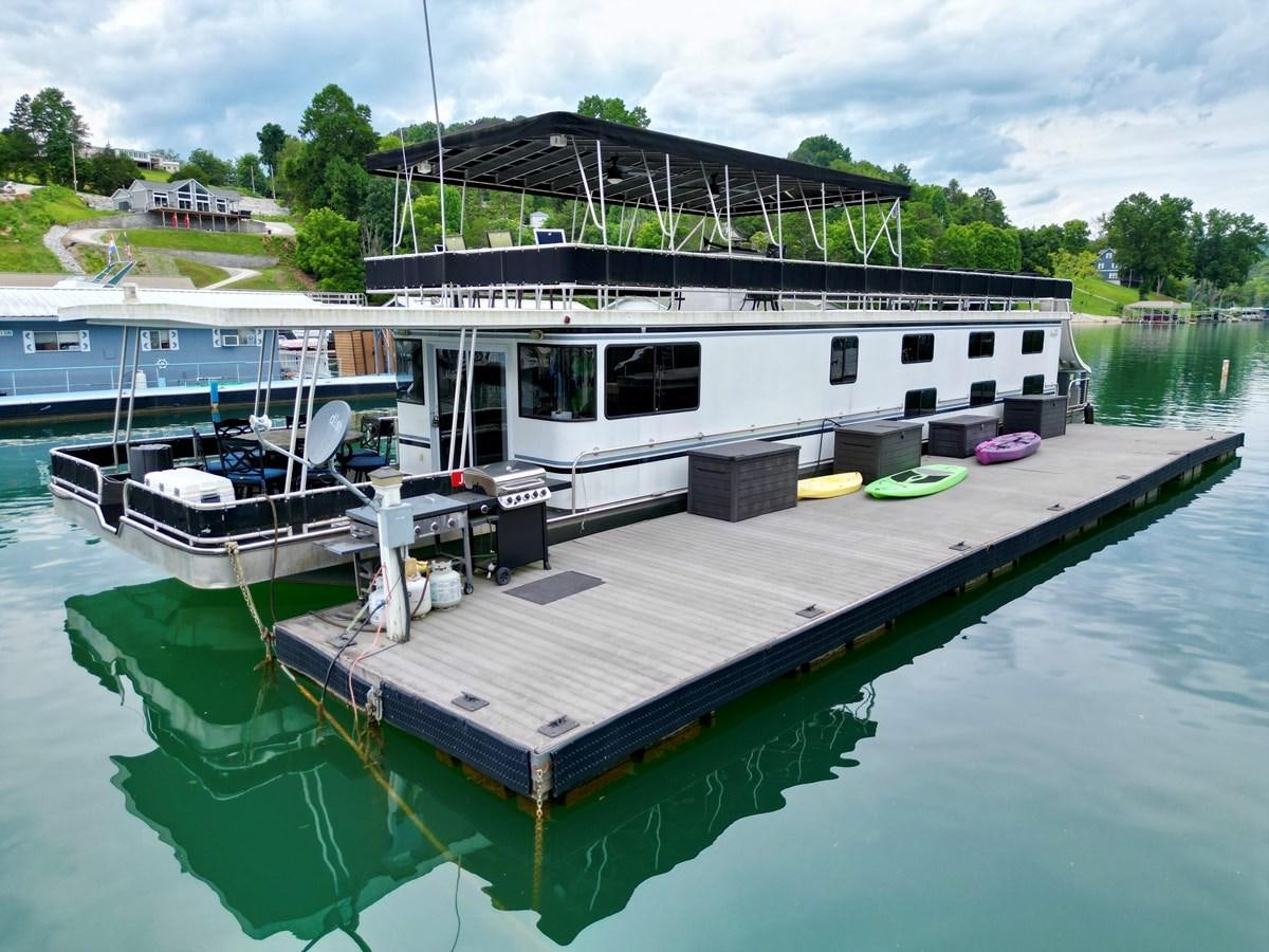 a boat docked at a pier aboard 2012 MAJESTIC 16 X 75WB HOUSEBOAT NLSD Yacht for Sale