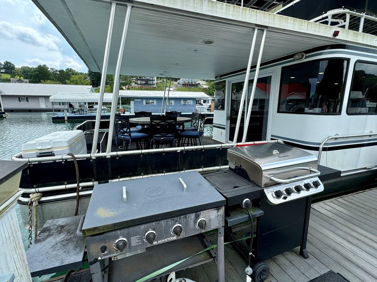 a boat on the water aboard 2012 MAJESTIC 16 X 75WB HOUSEBOAT NLSD Yacht for Sale