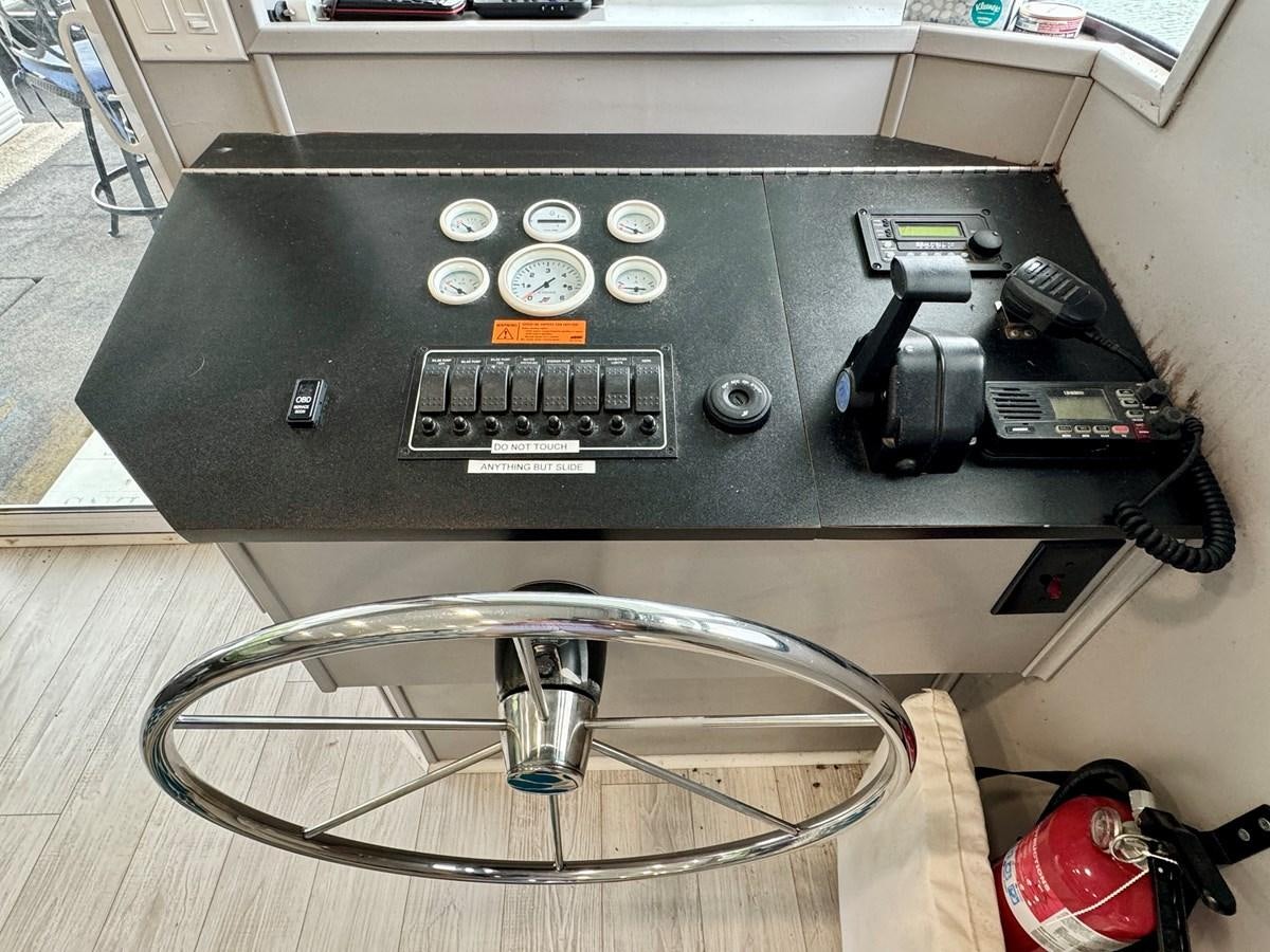 a black rectangular object with buttons aboard 2012 MAJESTIC 16 X 75WB HOUSEBOAT NLSD Yacht for Sale