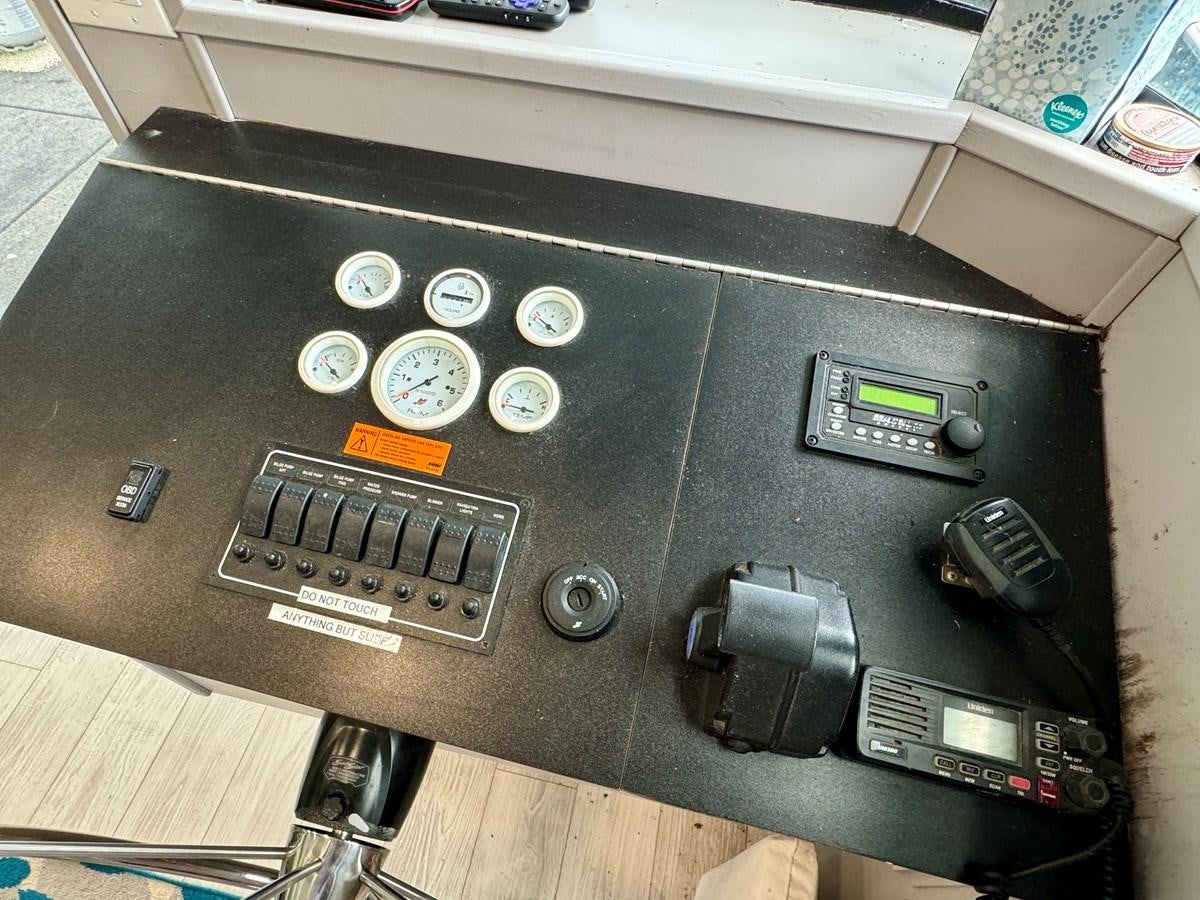 a black rectangular object with buttons aboard 2012 MAJESTIC 16 X 75WB HOUSEBOAT NLSD Yacht for Sale