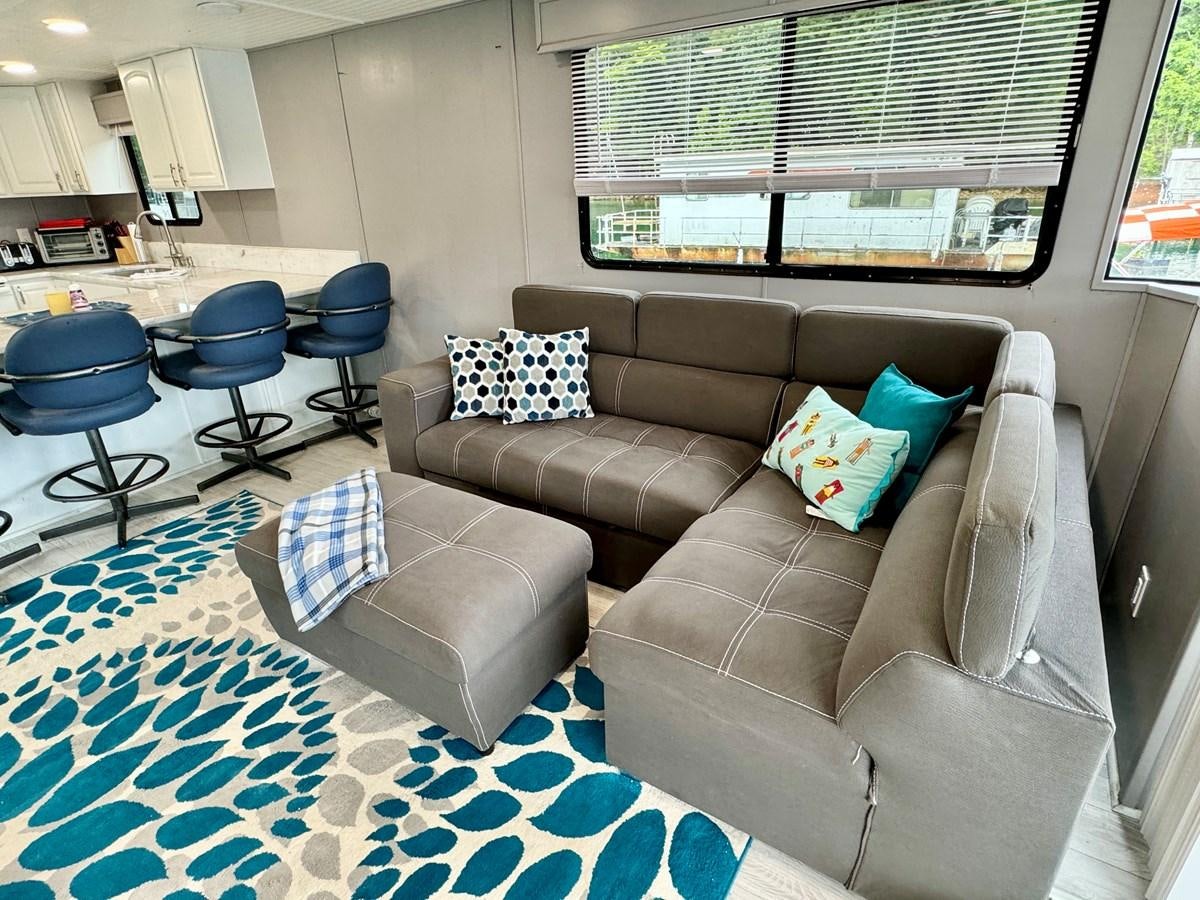 a couch in a room aboard 2012 MAJESTIC 16 X 75WB HOUSEBOAT NLSD Yacht for Sale