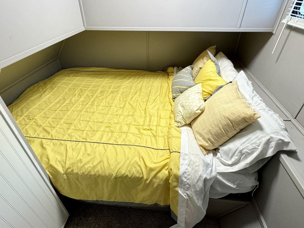 a bed with white sheets aboard 2012 MAJESTIC 16 X 75WB HOUSEBOAT NLSD Yacht for Sale