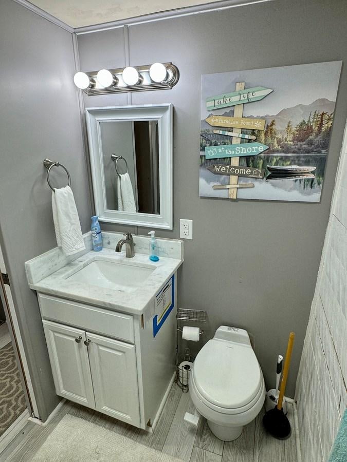 a bathroom with a sink and toilet aboard 2012 MAJESTIC 16 X 75WB HOUSEBOAT NLSD Yacht for Sale