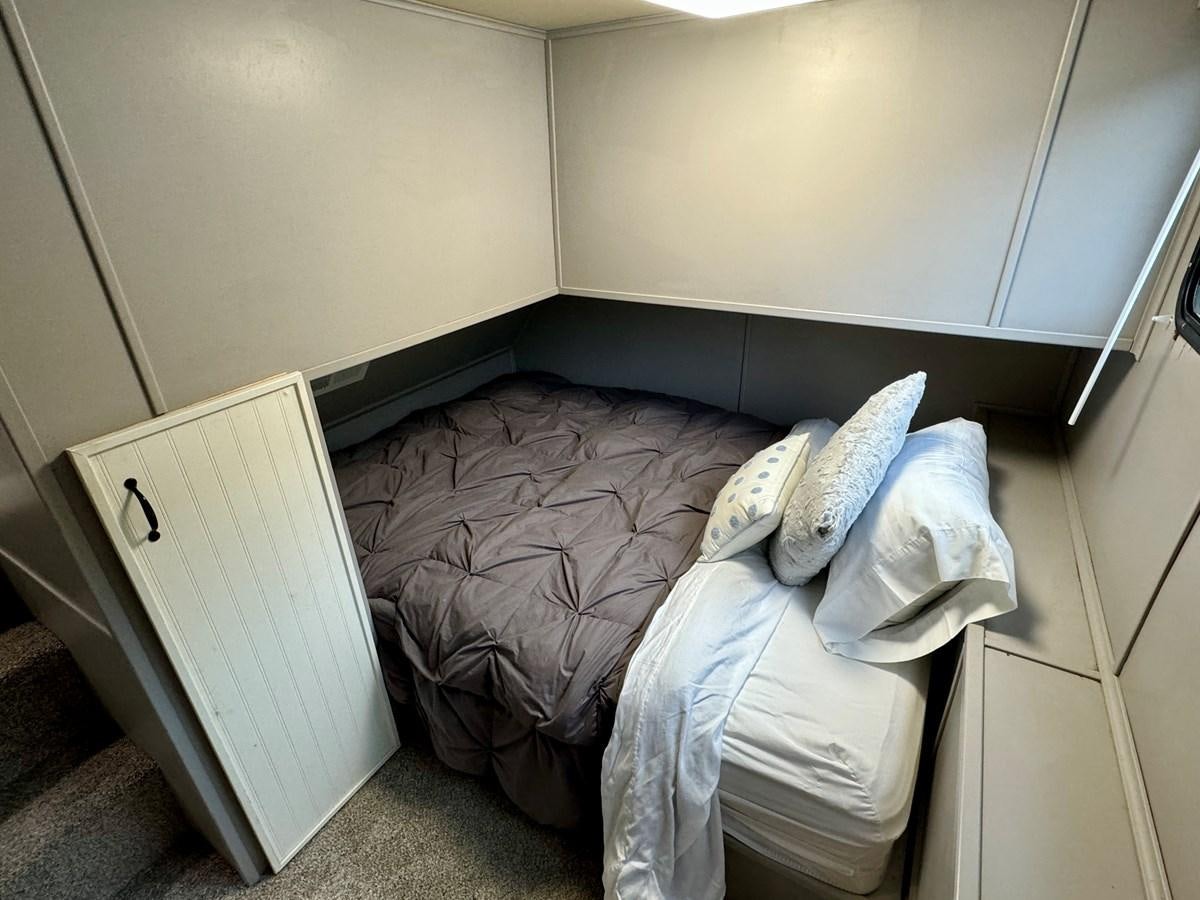 a bed in a room aboard 2012 MAJESTIC 16 X 75WB HOUSEBOAT NLSD Yacht for Sale