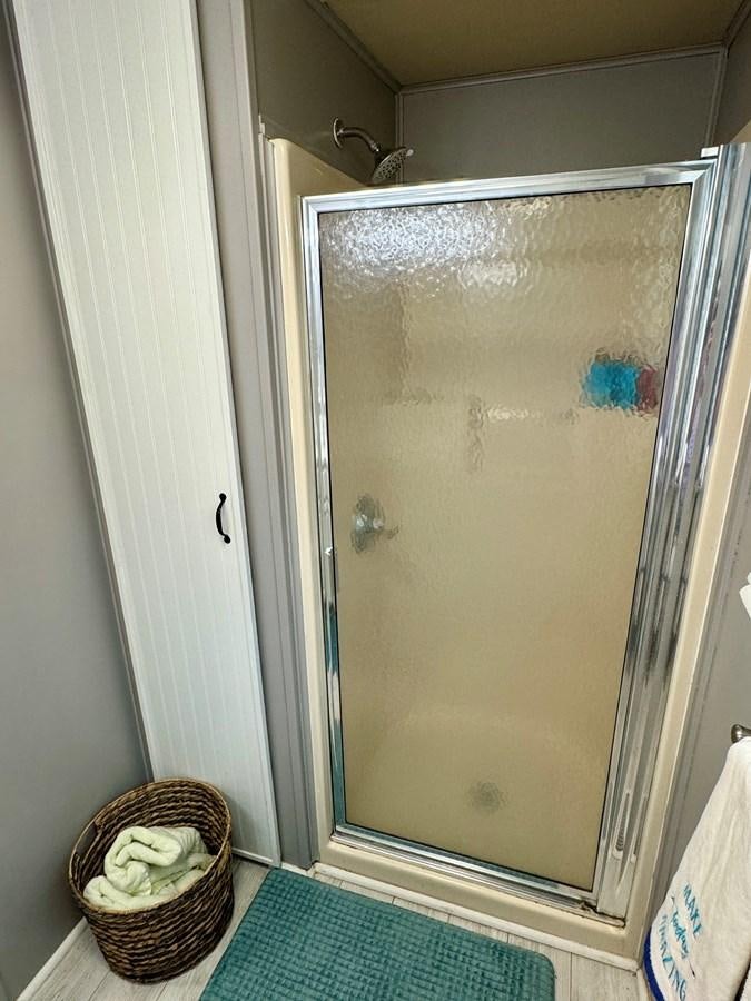 a basket of flowers next to a shower aboard 2012 MAJESTIC 16 X 75WB HOUSEBOAT NLSD Yacht for Sale