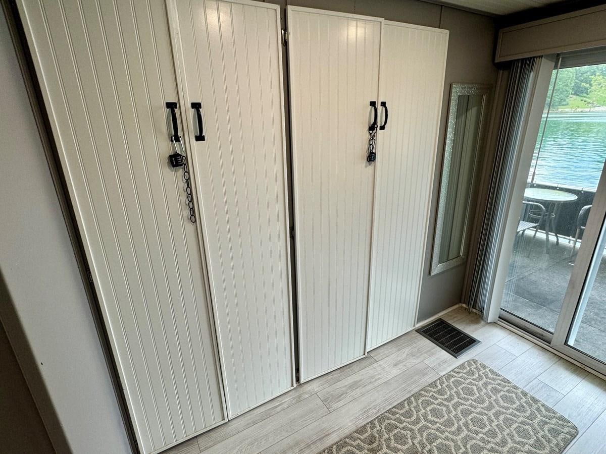 a room with a door and a window aboard 2012 MAJESTIC 16 X 75WB HOUSEBOAT NLSD Yacht for Sale