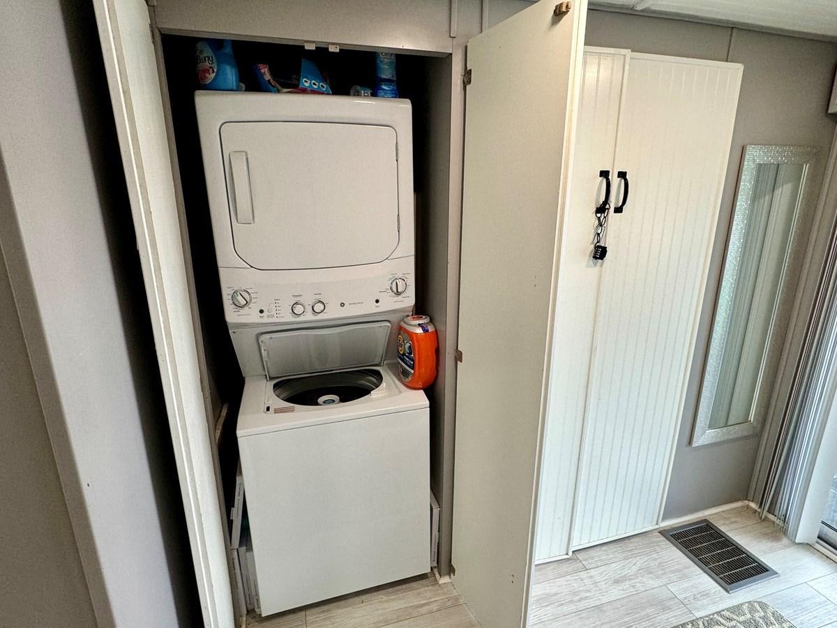 a small kitchen with a microwave aboard 2012 MAJESTIC 16 X 75WB HOUSEBOAT NLSD Yacht for Sale