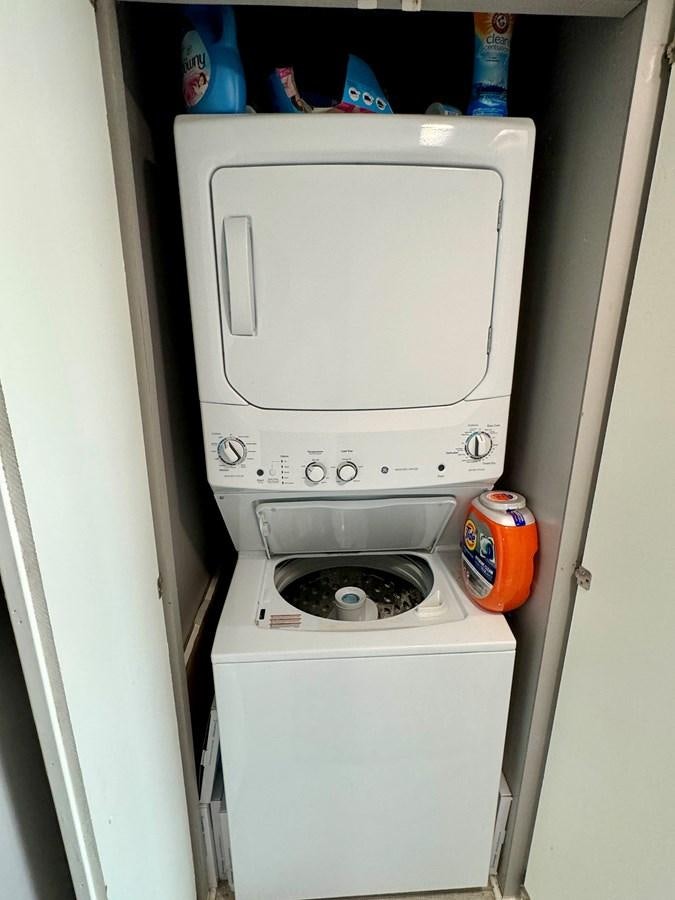 a white machine with a red label aboard 2012 MAJESTIC 16 X 75WB HOUSEBOAT NLSD Yacht for Sale