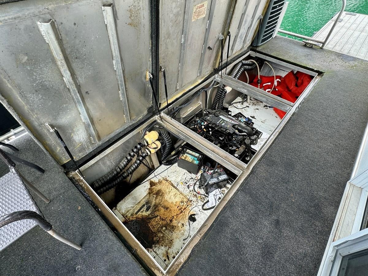 a car with a car hood aboard 2012 MAJESTIC 16 X 75WB HOUSEBOAT NLSD Yacht for Sale