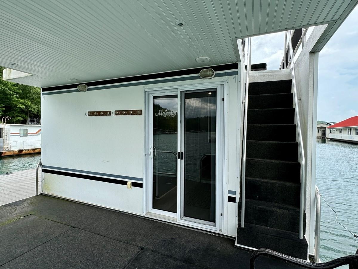 a boat on the water aboard 2012 MAJESTIC 16 X 75WB HOUSEBOAT NLSD Yacht for Sale