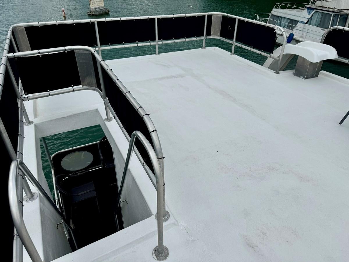 a white boat on the snow aboard 2012 MAJESTIC 16 X 75WB HOUSEBOAT NLSD Yacht for Sale