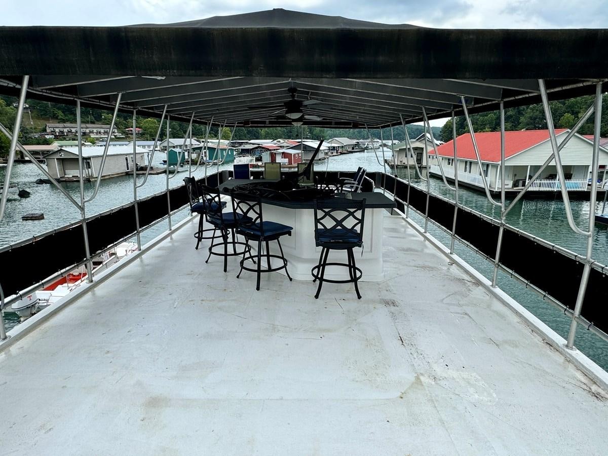 chairs on a deck aboard 2012 MAJESTIC 16 X 75WB HOUSEBOAT NLSD Yacht for Sale