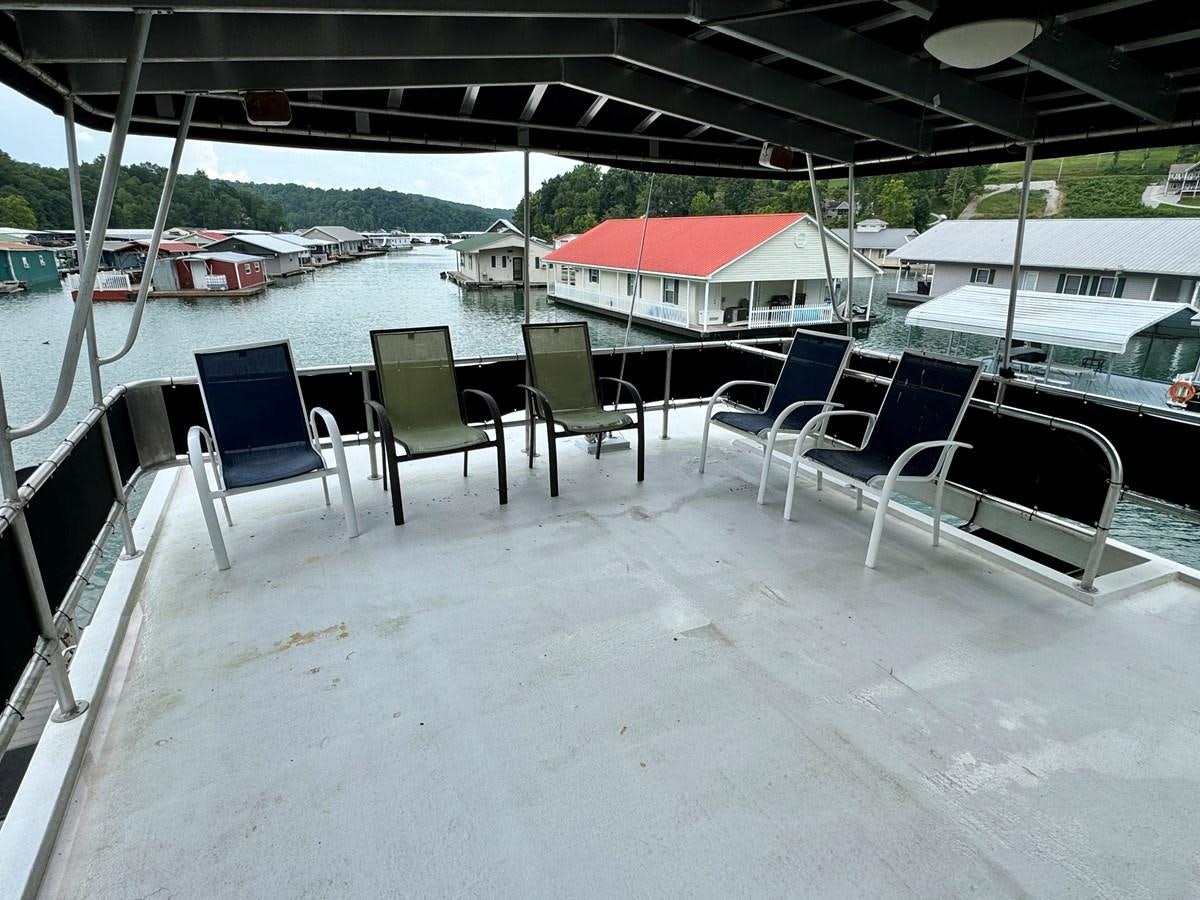 a group of chairs on a deck aboard 2012 MAJESTIC 16 X 75WB HOUSEBOAT NLSD Yacht for Sale