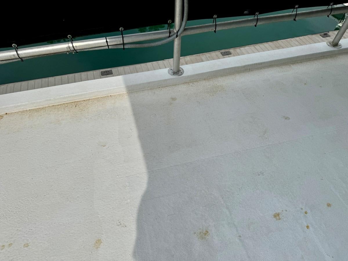 a white surface with a metal railing aboard 2012 MAJESTIC 16 X 75WB HOUSEBOAT NLSD Yacht for Sale