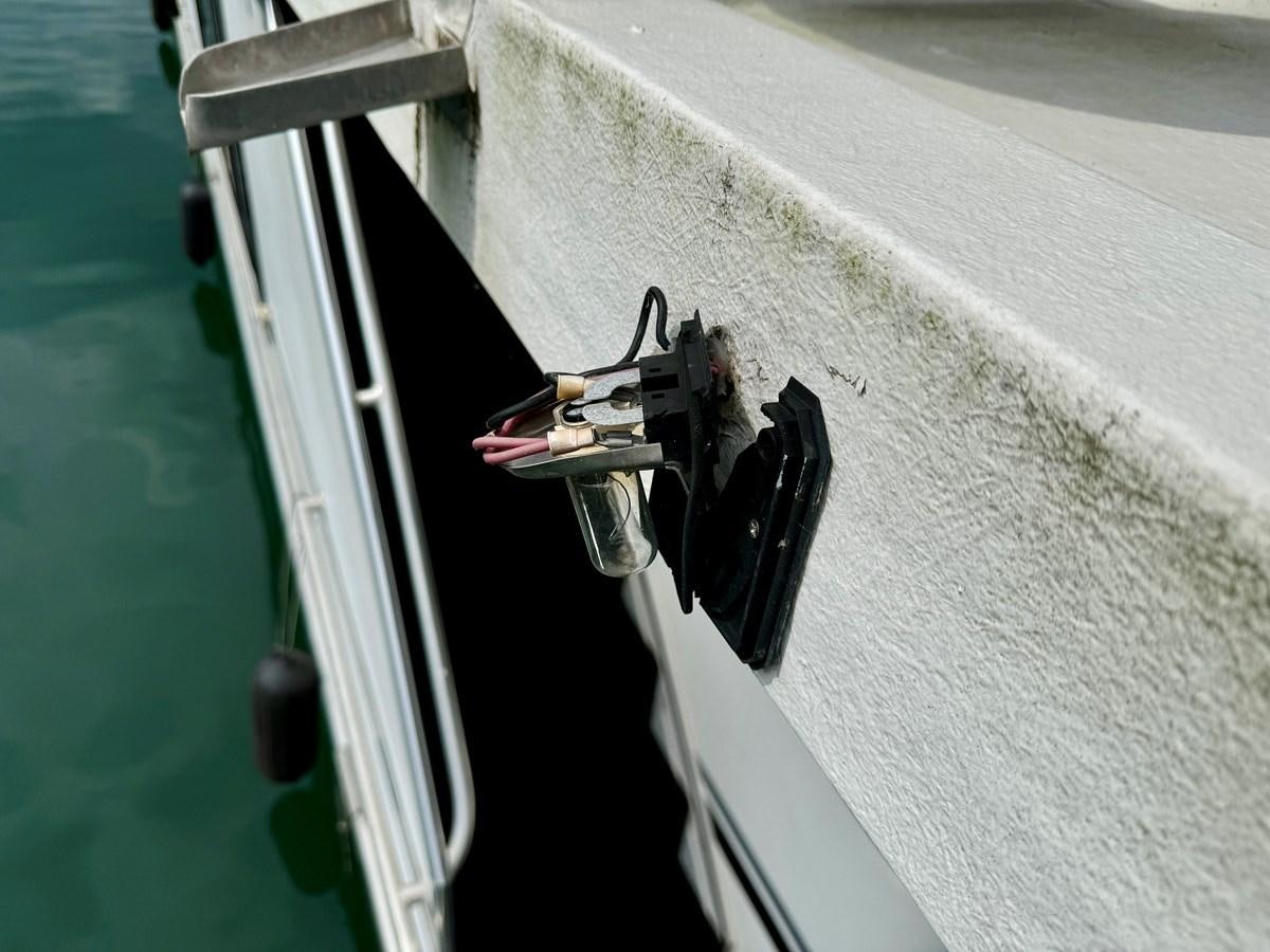 a black object on a surface aboard 2012 MAJESTIC 16 X 75WB HOUSEBOAT NLSD Yacht for Sale