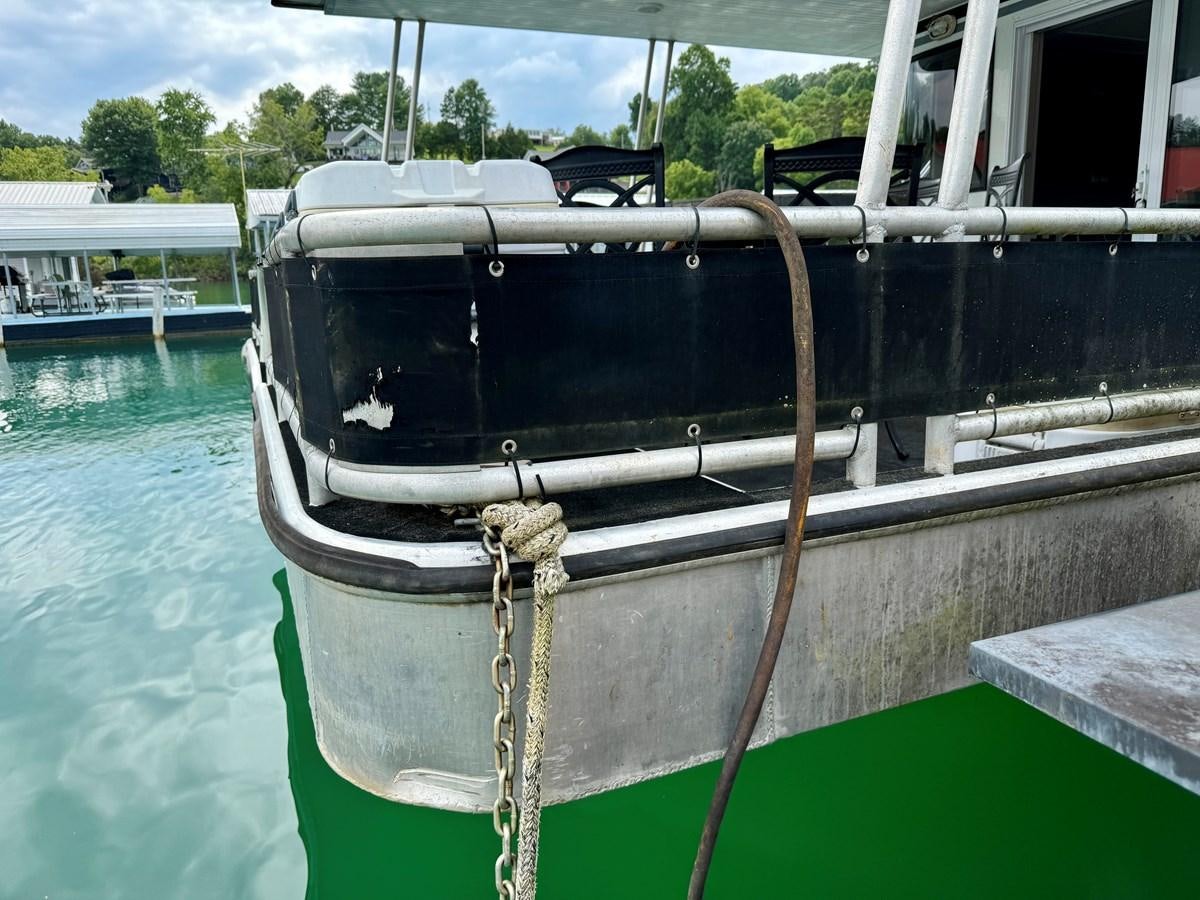 a boat tied to a dock aboard 2012 MAJESTIC 16 X 75WB HOUSEBOAT NLSD Yacht for Sale