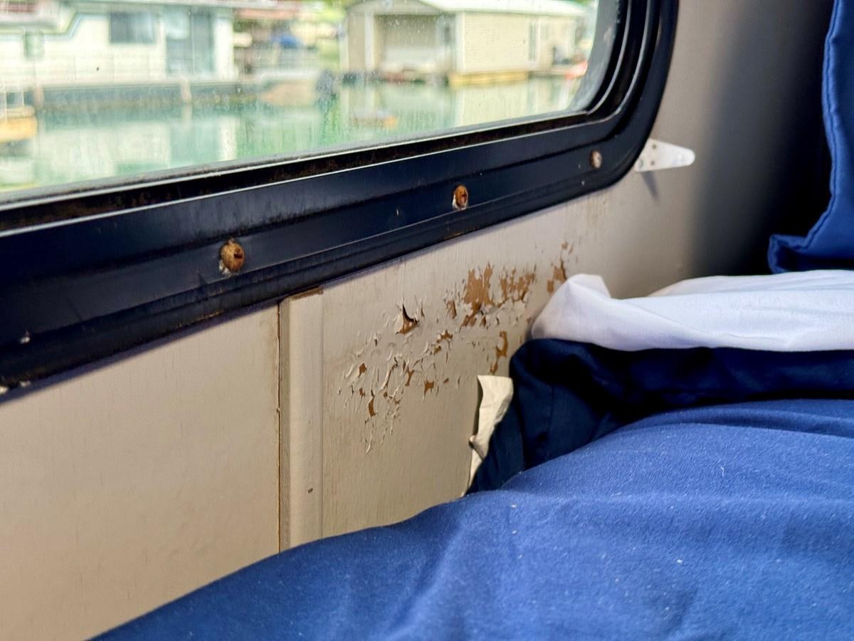 a window with a blue blanket and a blue blanket aboard 2012 MAJESTIC 16 X 75WB HOUSEBOAT NLSD Yacht for Sale