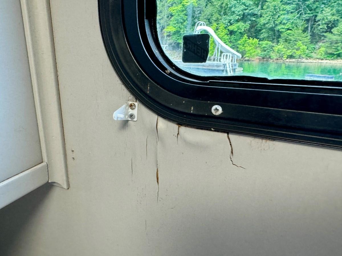 a window with a broken screen aboard 2012 MAJESTIC 16 X 75WB HOUSEBOAT NLSD Yacht for Sale