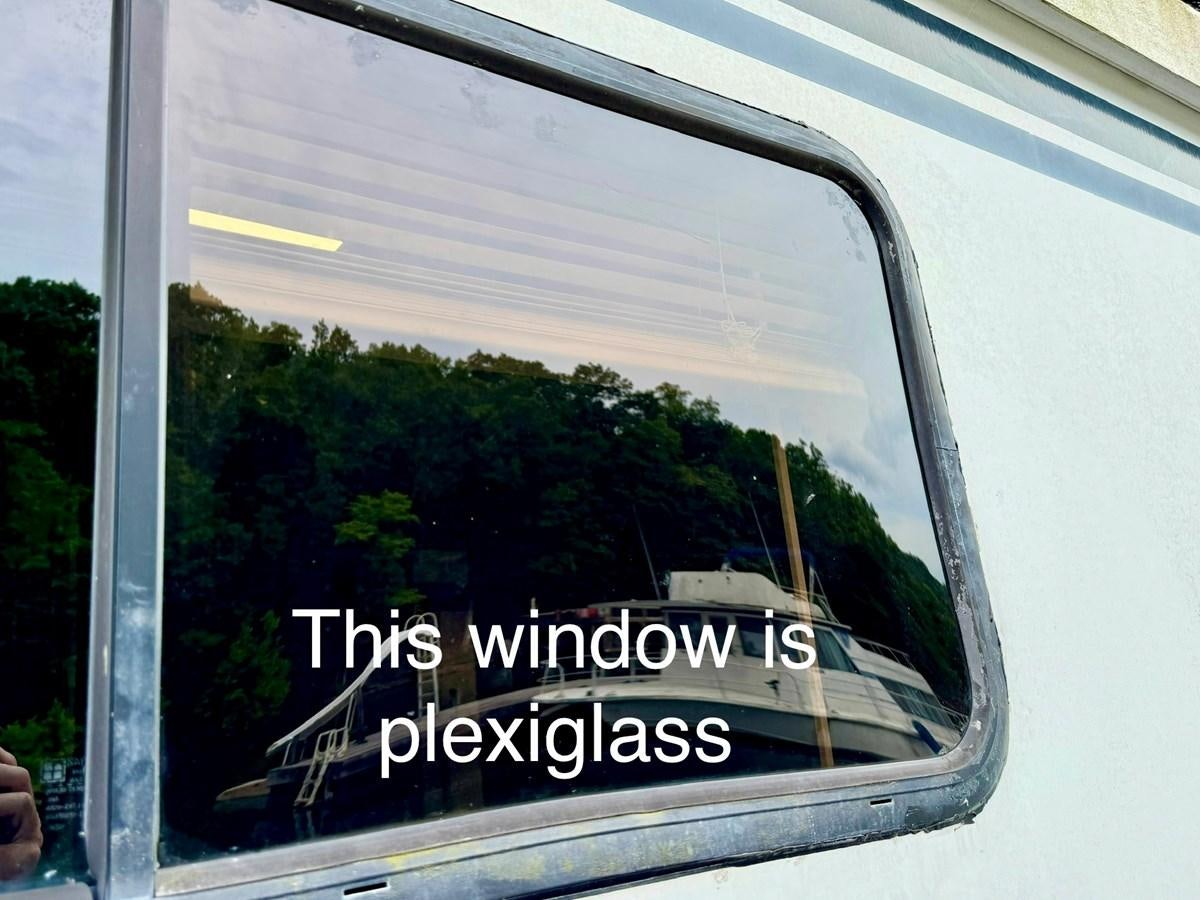 a side view mirror of a car aboard 2012 MAJESTIC 16 X 75WB HOUSEBOAT NLSD Yacht for Sale