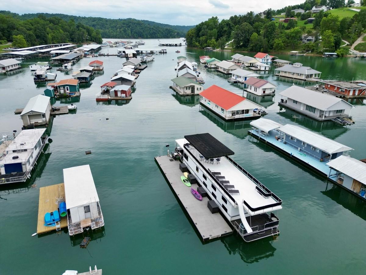 a group of boats docked aboard 2012 MAJESTIC 16 X 75WB HOUSEBOAT NLSD Yacht for Sale