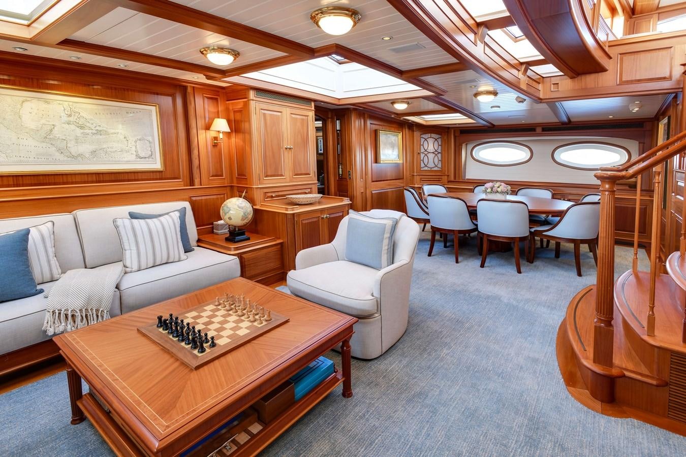 a large living room with a large table and chairs aboard ANNE Yacht for Sale