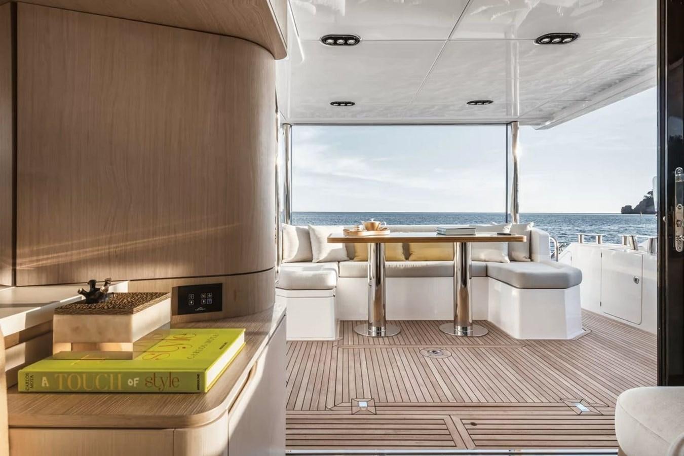 a room with a table and chairs aboard 2023 AZIMUT FLY 78/56 Yacht for Sale