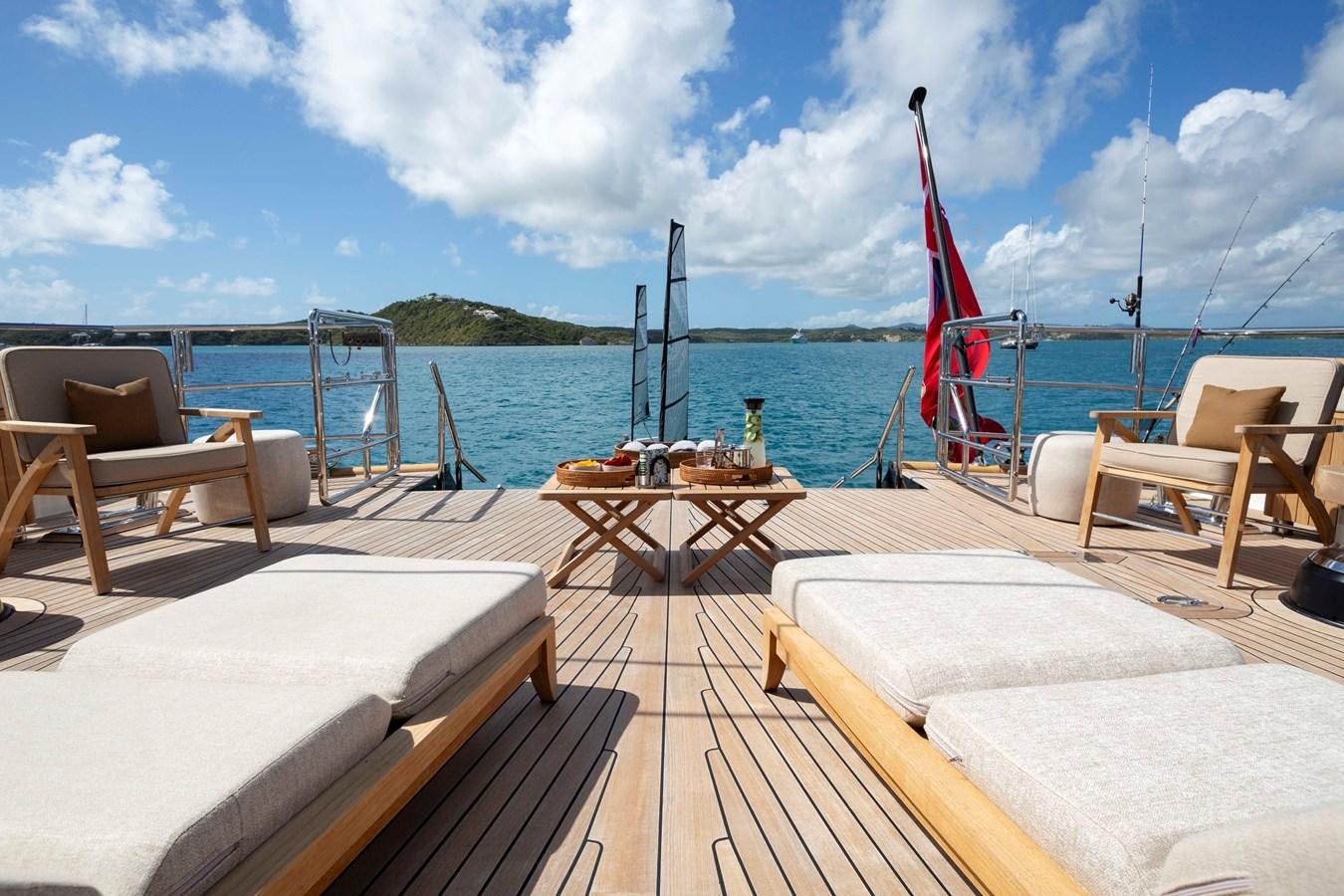 a deck with a view of the ocean and a boat on it aboard ASAHI Yacht for Sale