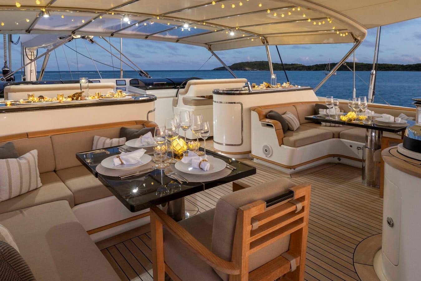 a yacht with a table set for a dinner party aboard ASAHI Yacht for Sale