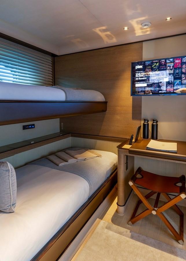 a room with a bed and desk aboard ASAHI Yacht for Sale