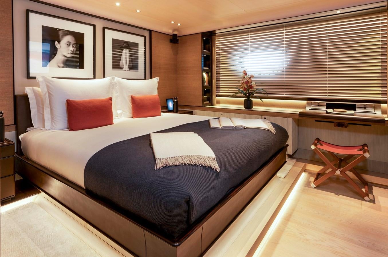 a bed with pillows and a chair aboard ASAHI Yacht for Sale