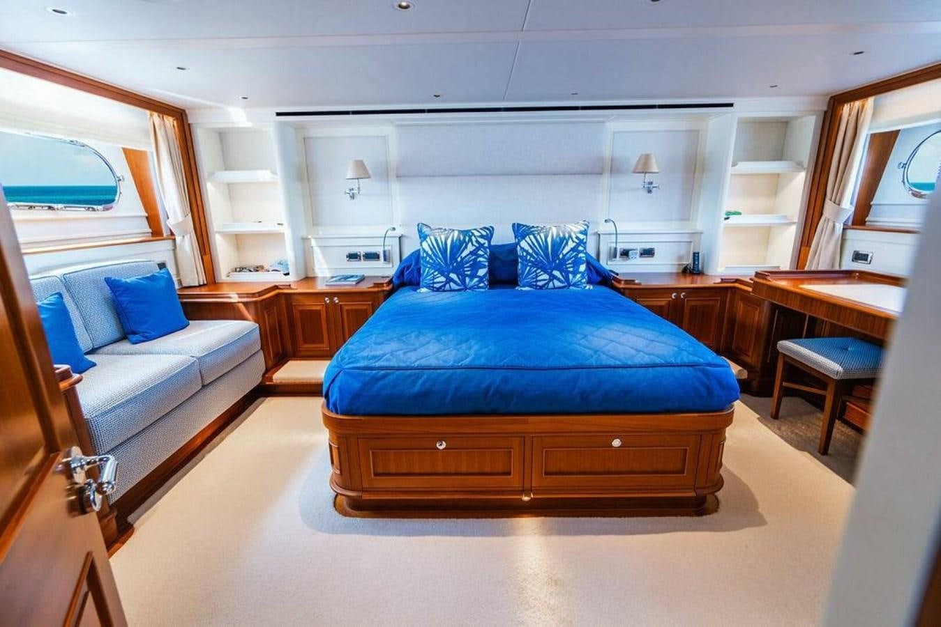 a bedroom with a bed and a couch aboard PHOEBE Yacht for Sale