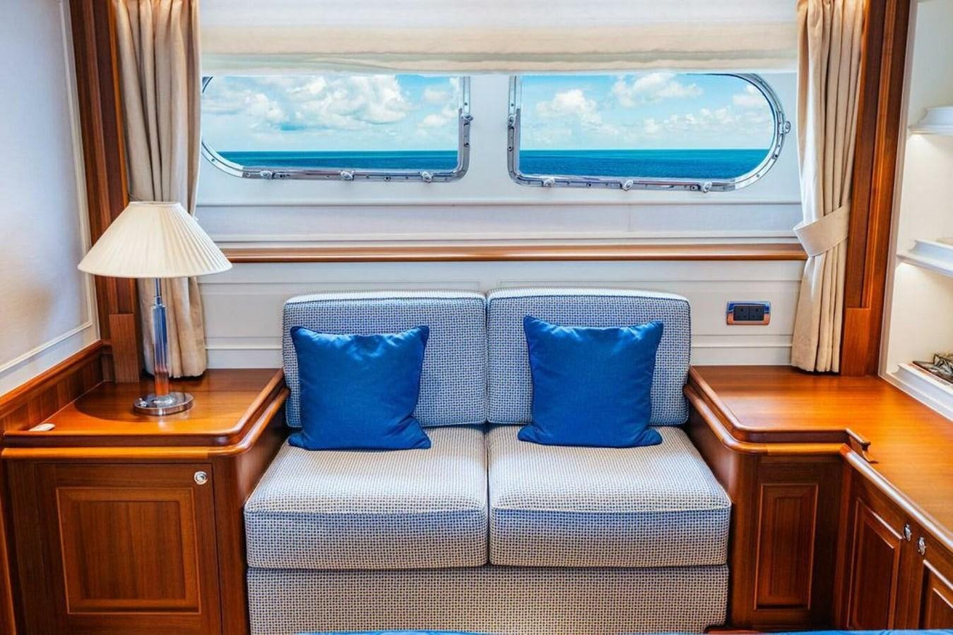 a living room with a large window aboard PHOEBE Yacht for Sale