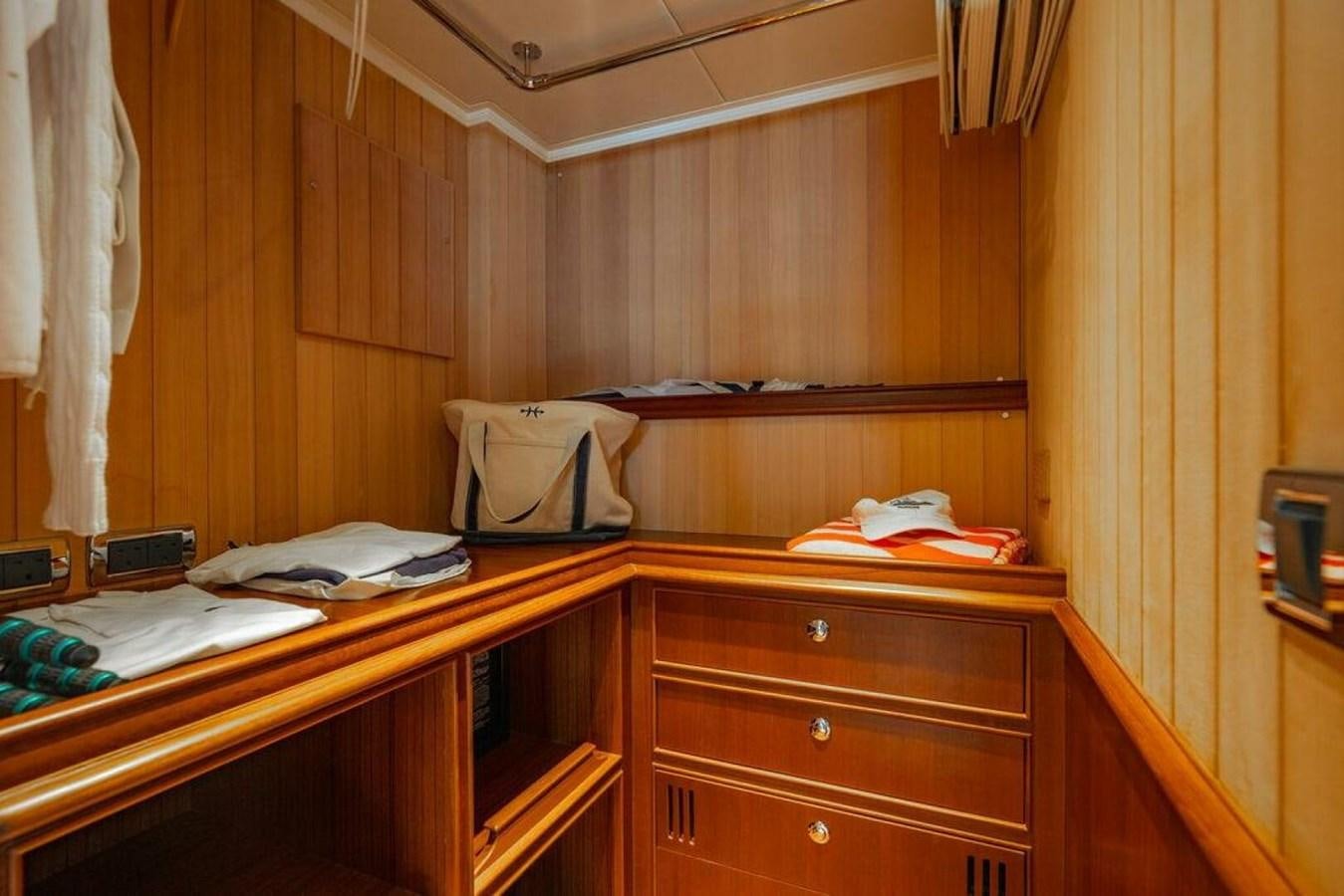a room with a desk and a bed aboard PHOEBE Yacht for Sale