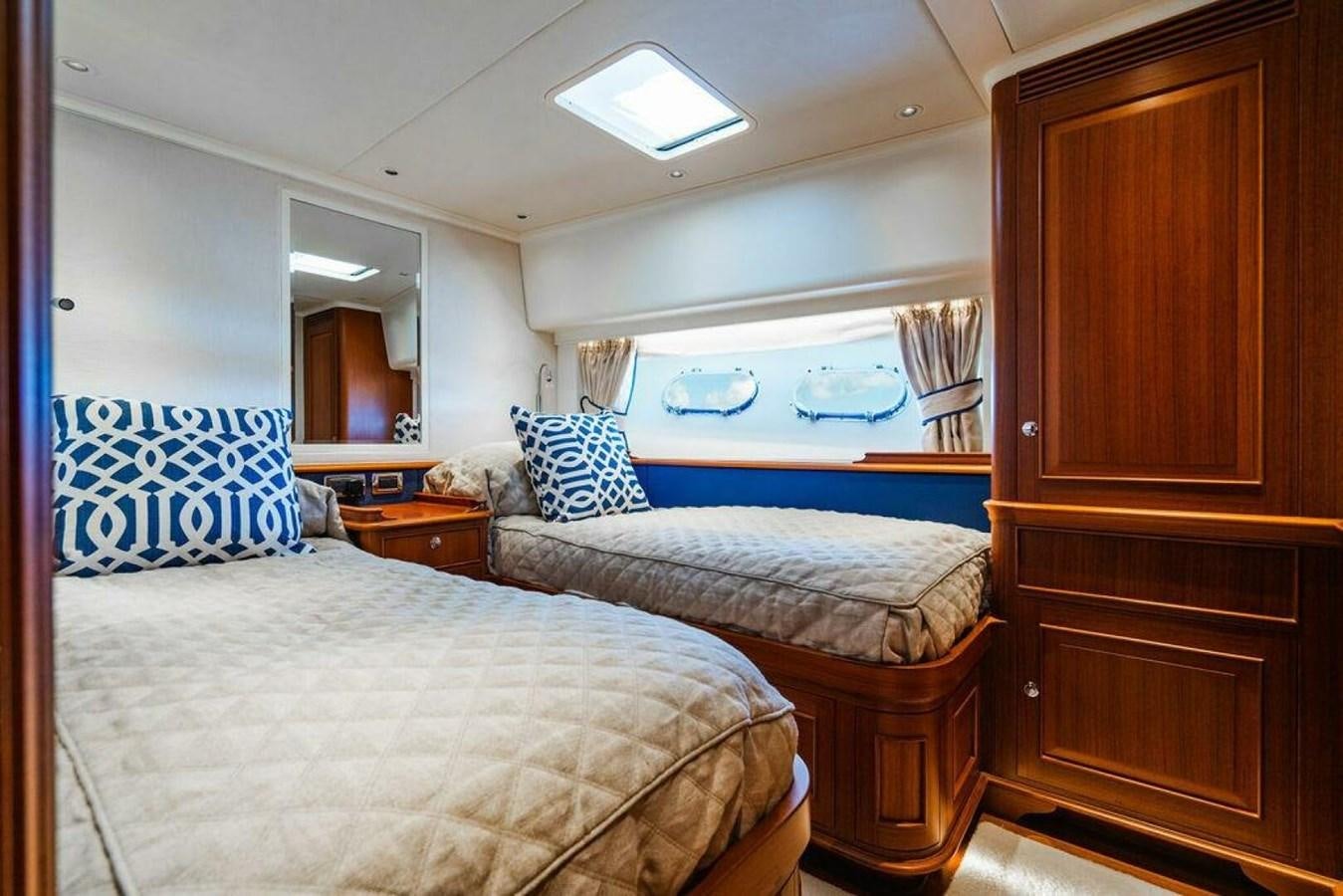 a bedroom with two beds aboard PHOEBE Yacht for Sale