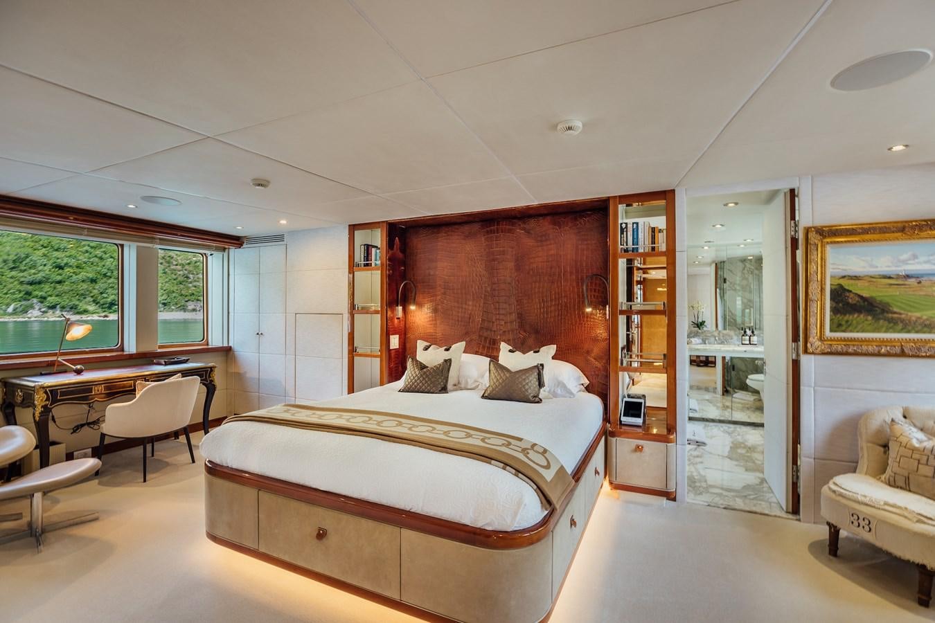 a bedroom with a bed and a desk aboard ZULU Yacht for Sale