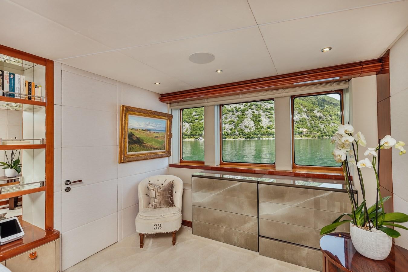 a room with a chair and a window aboard ZULU Yacht for Sale