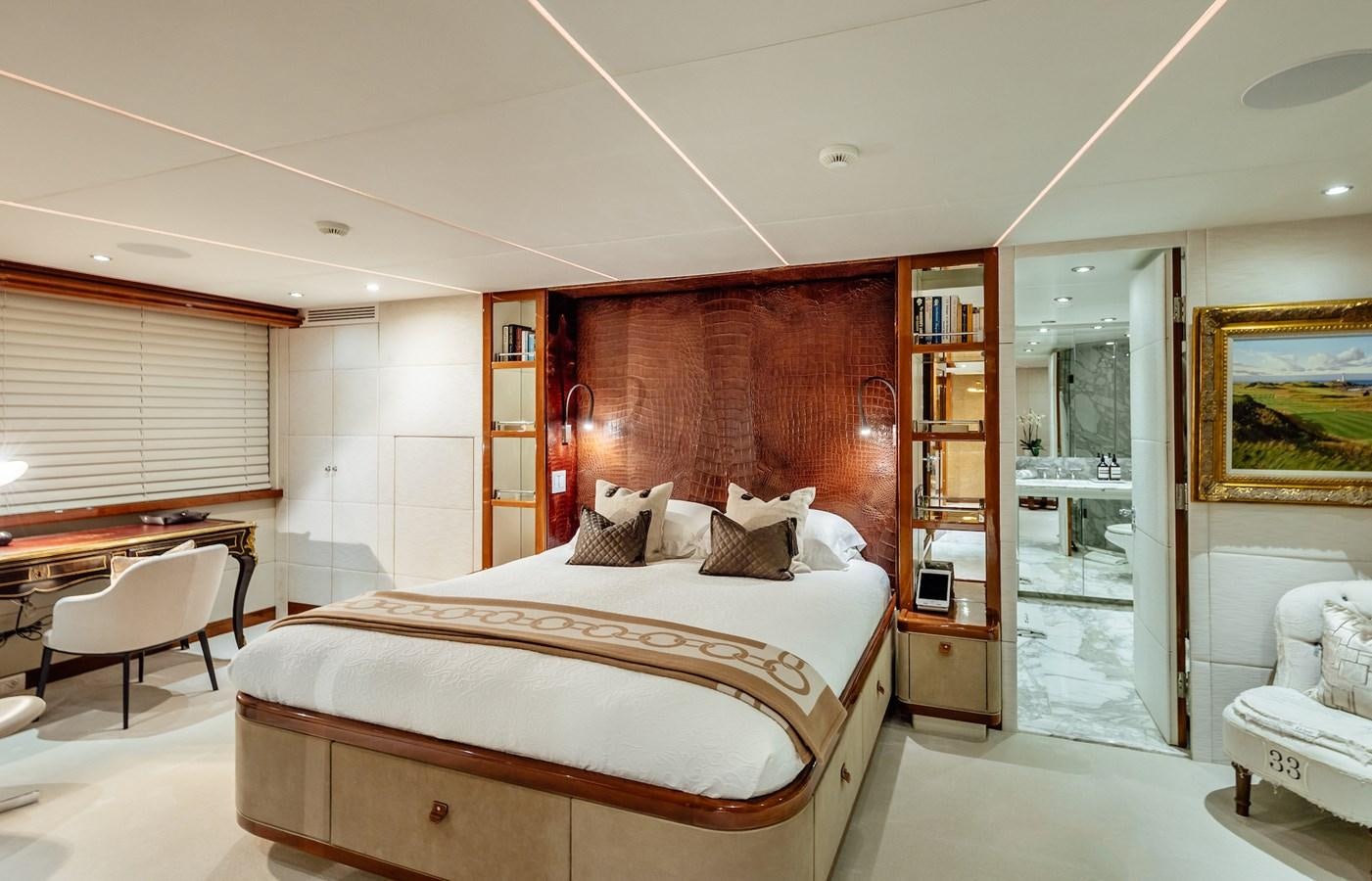 a bedroom with a bed and a desk aboard ZULU Yacht for Sale