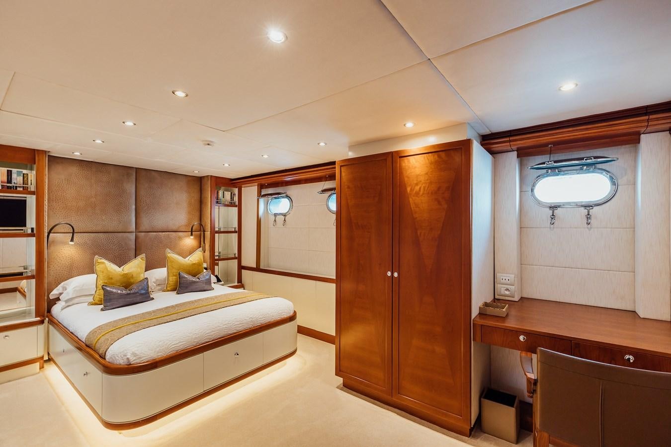 a bedroom with a bed and a closet aboard ZULU Yacht for Sale
