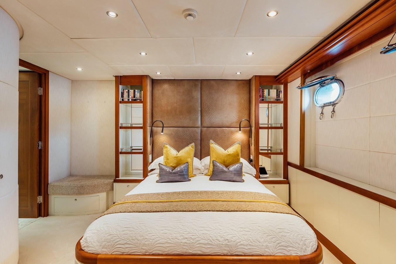 a room with a bed and a bookcase aboard ZULU Yacht for Sale