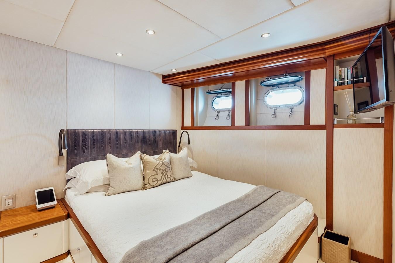 a room with a bed and a desk aboard ZULU Yacht for Sale