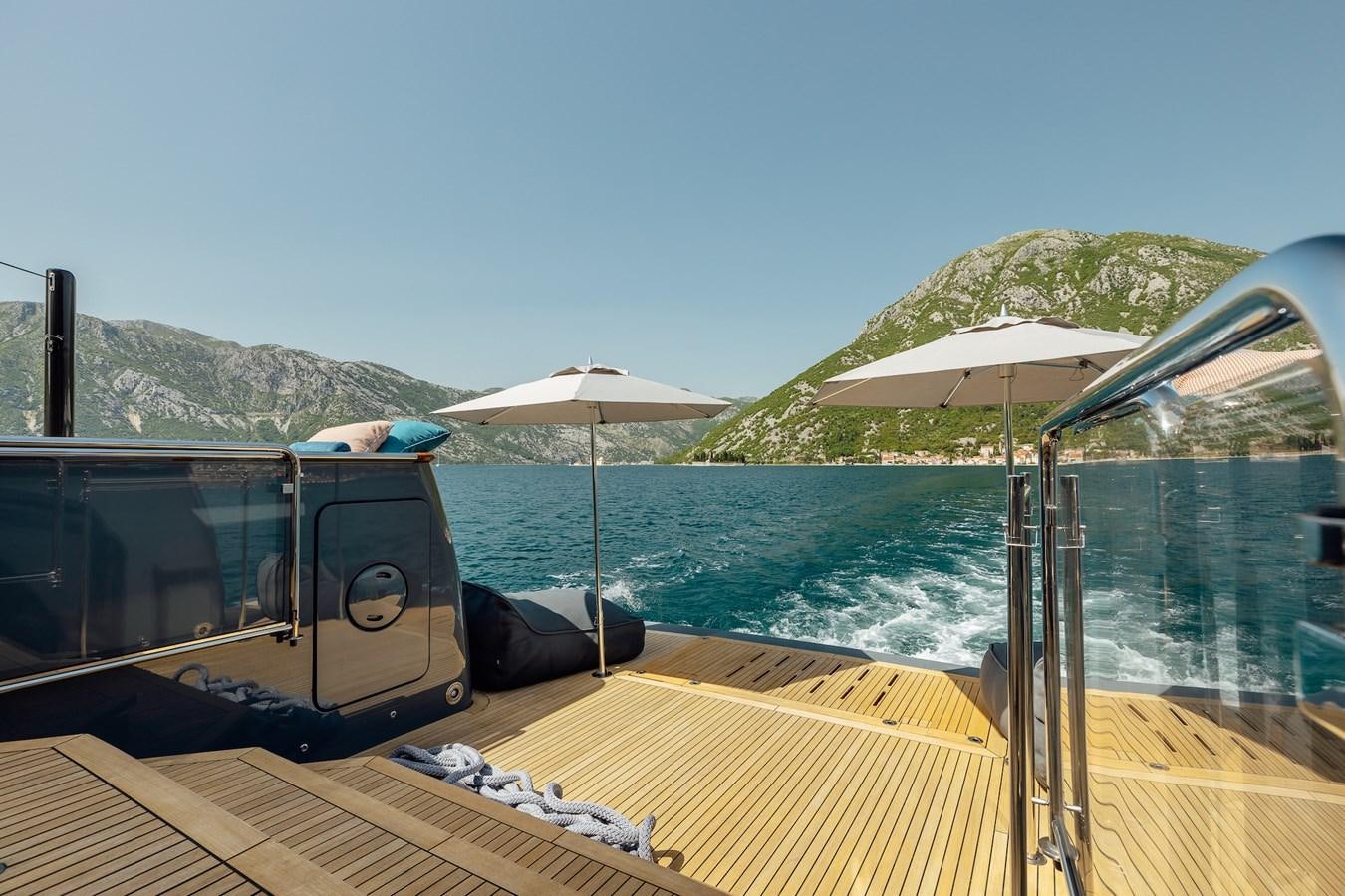 a boat with umbrellas on the water aboard ZULU Yacht for Sale