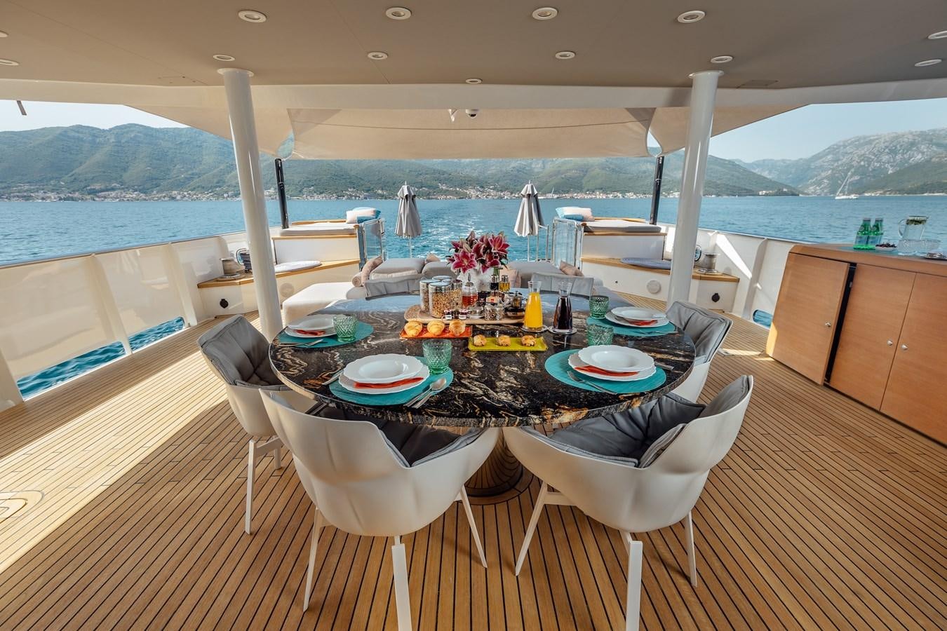 a table set with plates and food aboard ZULU Yacht for Sale